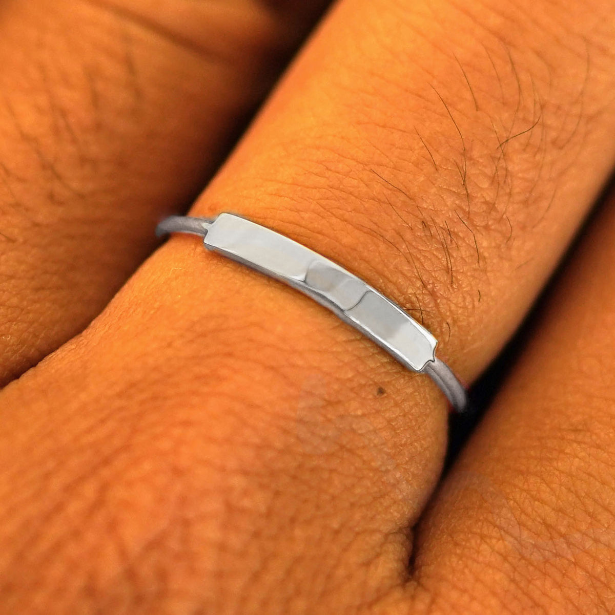 Close up view of a model's fingers wearing a white gold Bar Ring