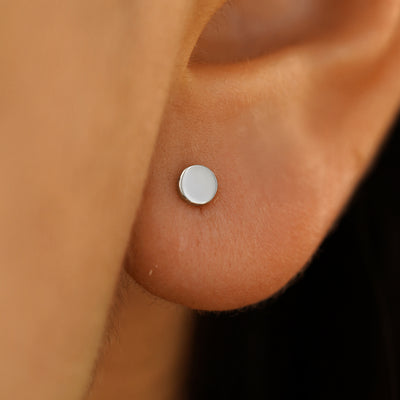 Close up view of a model's ear wearing a Medium Circle Earring in white gold.