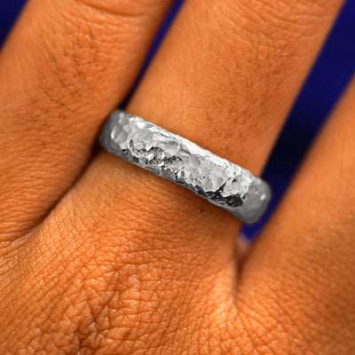 Close up view of a model's fingers wearing a 14k white gold Organic Band