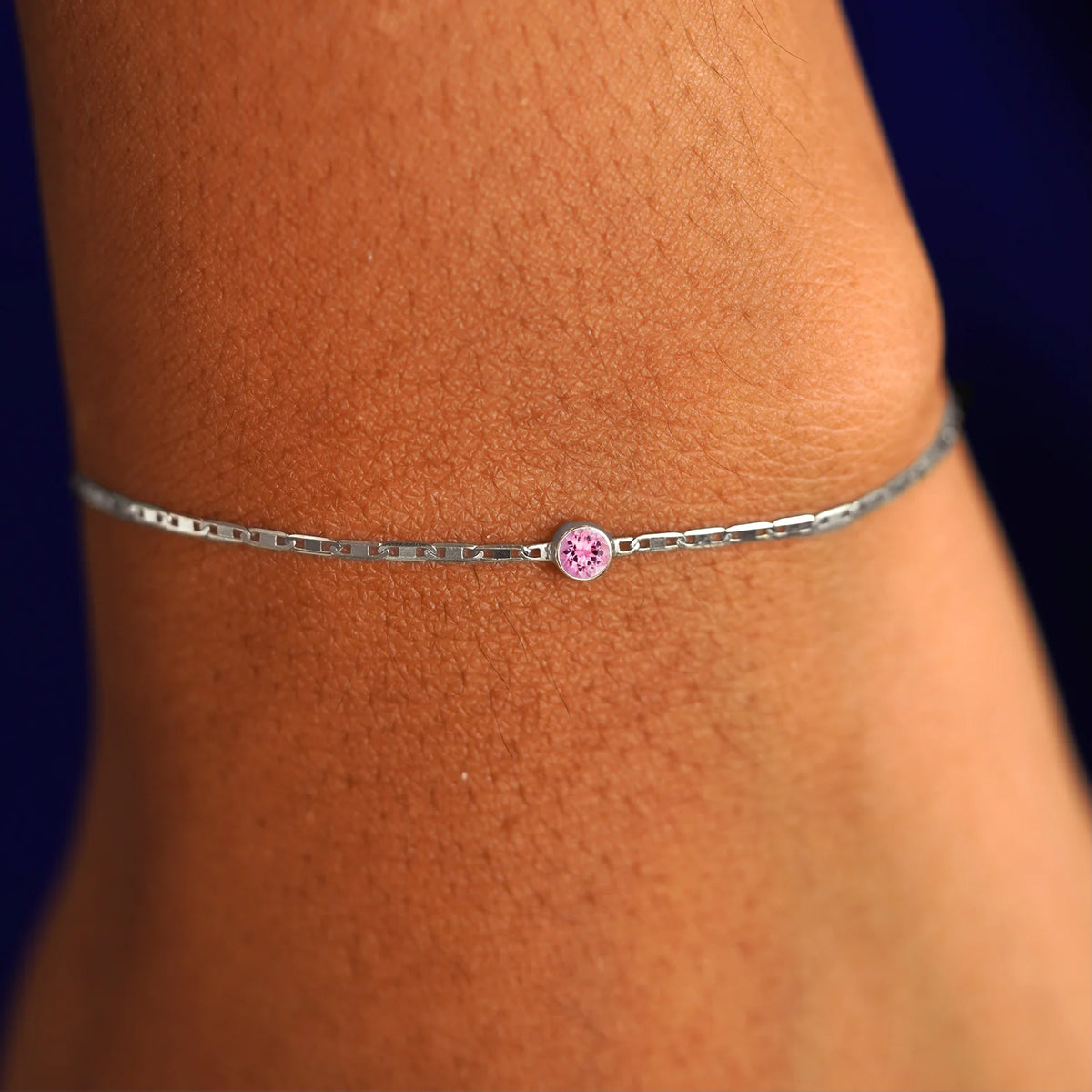 A model's wrist wearing a 14 karat white gold Pink Sapphire Bracelet