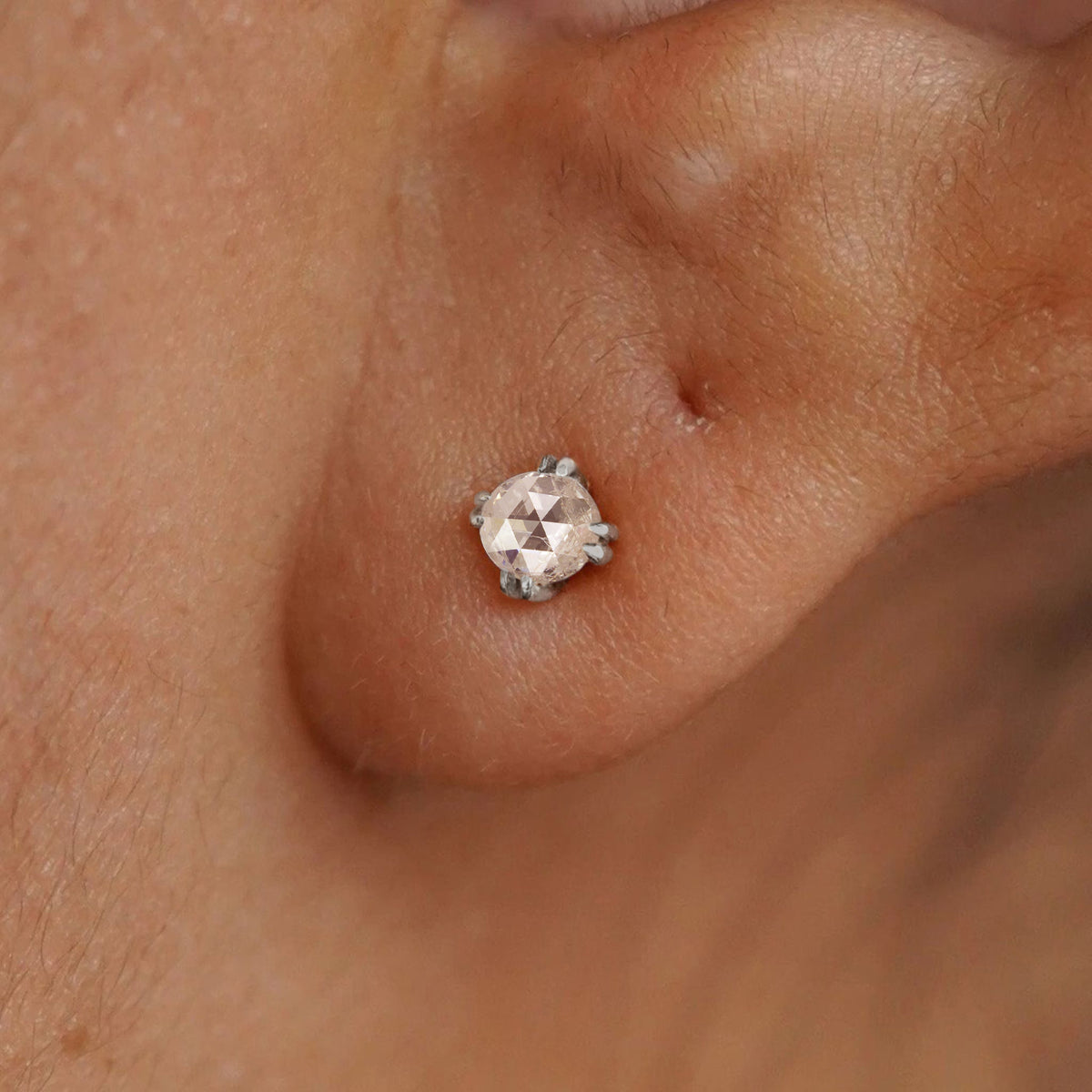 A model's ear wearing a 14k solid white gold Rose Cut Diamond Earring