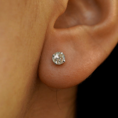 Close up view of a model's ear wearing a solid 14k white gold salt and pepper diamond pressure lock earring