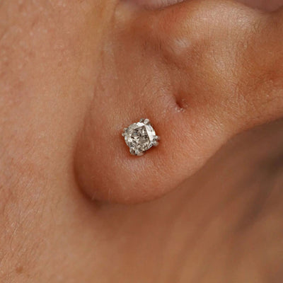 A model's ear wearing a 14k white gold Salt and Pepper Diamond Earring