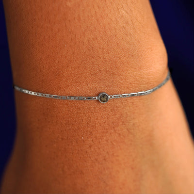 A model's wrist wearing a 14 karat white gold Smoky Quartz Bracelet