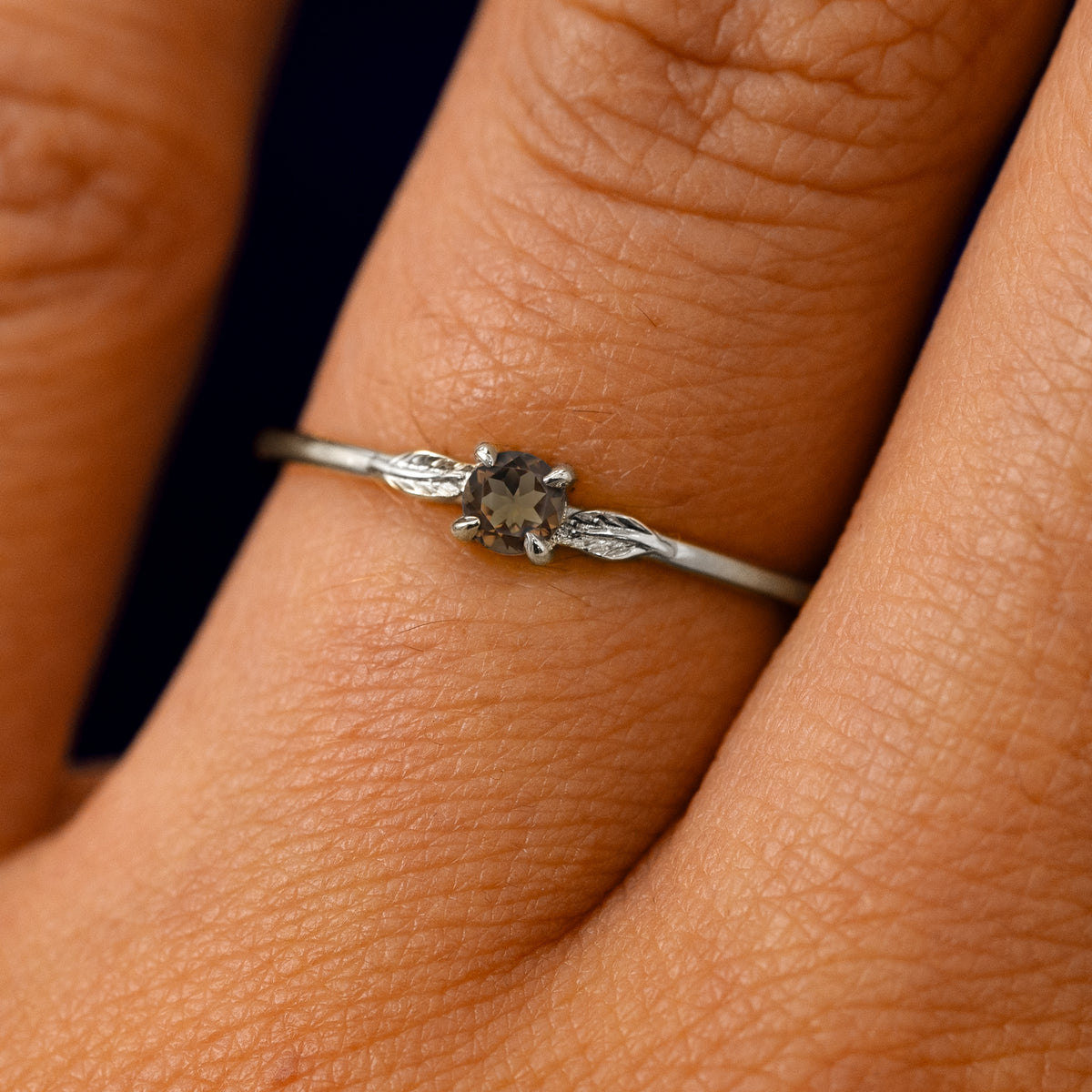 A solid 14k white gold Smoky Quartz Gemstone Two Leaf Ring on a model's finger