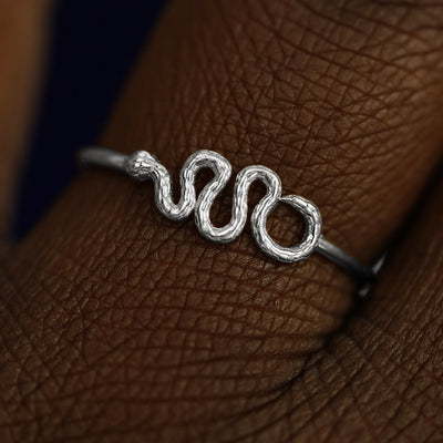 Close up view of a model's fingers wearing a 14k white gold Snake Ring