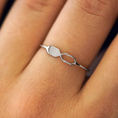 Close up view of a model's fingers wearing a 14k white gold Tanlah Ring