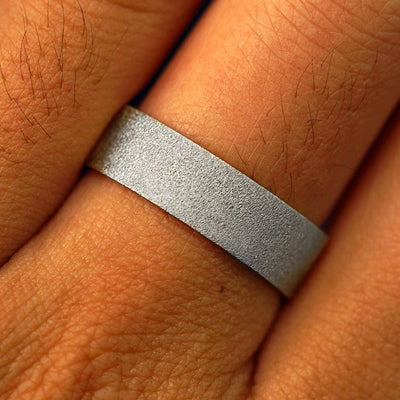 Close up view of a model's fingers wearing a 14k white gold Industrial Stardust Band