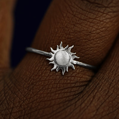 Close up view of a model's fingers wearing a 14k white gold Sun Ring