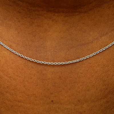 Close up view of a model's neck wearing a solid 14k white gold Thick Cable Chain