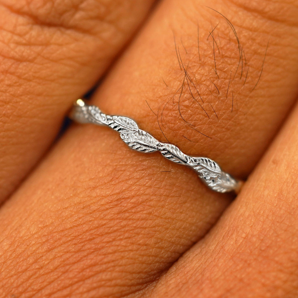 Close up view of a model's fingers wearing a 14k white gold Thin Leaves Band
