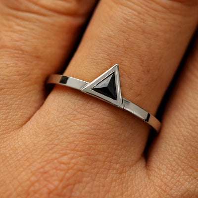 Close up view of a model's hand wearing a solid 14k white gold Triangle Diamond Ring