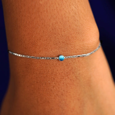 A model's wrist wearing a 14 karat white gold Turquoise Bracelet