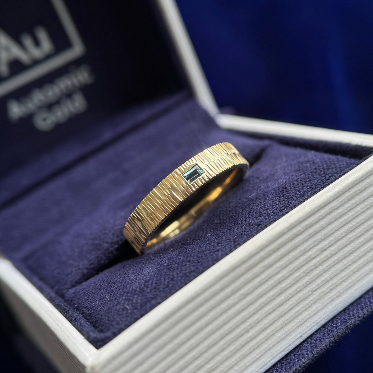 14k Yellow Gold and Flush-horizontal-set 3x2mm Teal Baguette on 4mm Wood Band Custom Ring, size 6.75