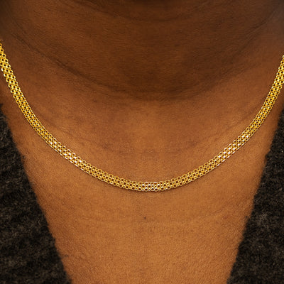 Close up view of a models neck wearing a solid 14k yellow gold Bismark Chain Necklace