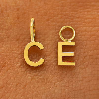 Two versions of the Block Initial Charm in the letters C and E showing For Chain and For Earring options in yellow gold