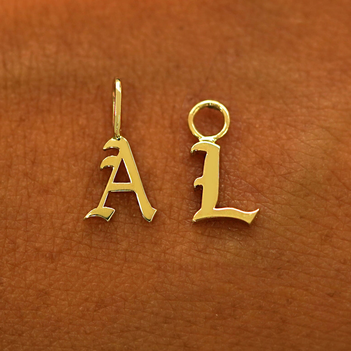 Two versions of the Initial Charm in the letter A and the letter L showing For Chain and For Earring options respectively