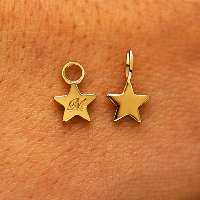 Two solid 14k yellow gold Star Charms showing the for chain and the for earring options