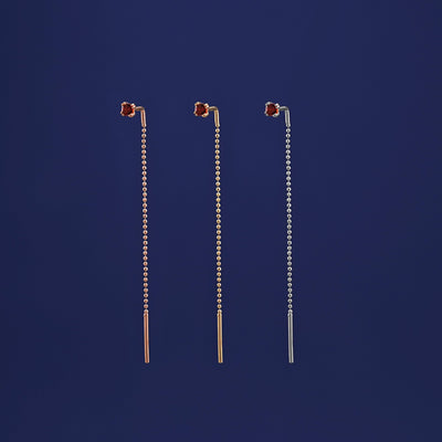 Three versions of the garnet Gemstone Threader shown in options of rose, yellow, and white gold