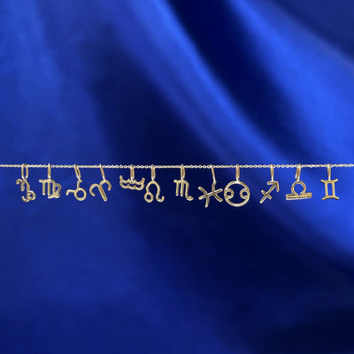 Twelve Horoscope Charms showing all of the zodiac symbol options on a yellow gold Cable Chain