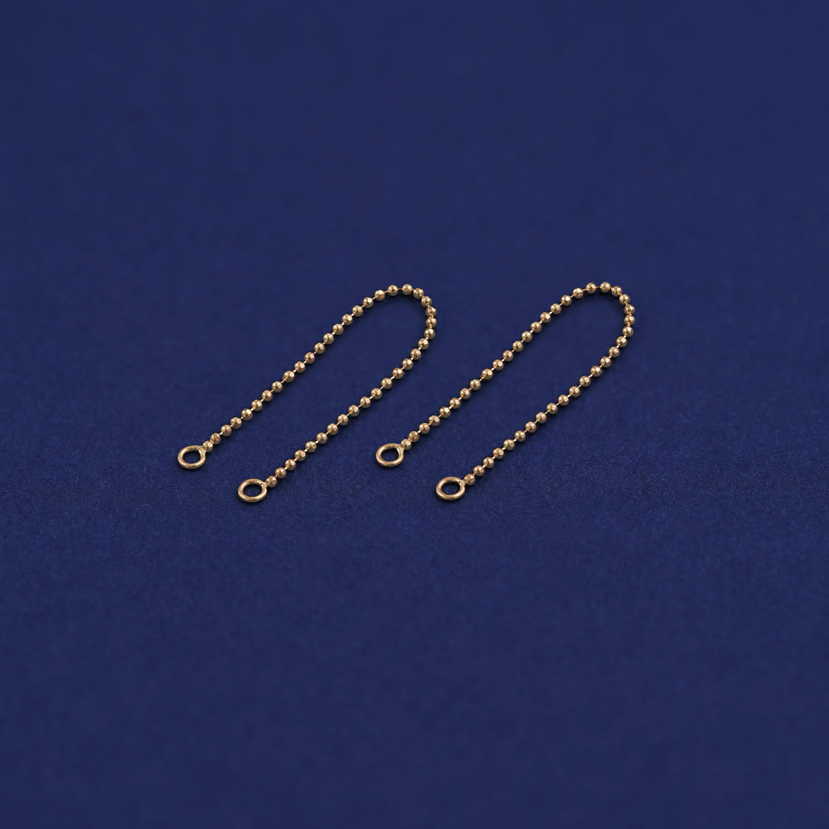 Two yellow gold Connectors laid out to show detail